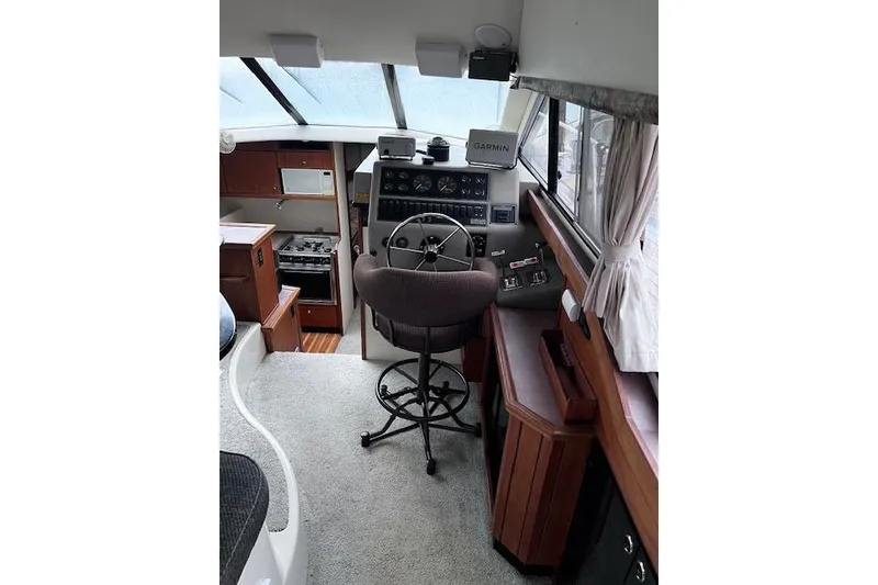 Slide: The Image of 1996 Bayliner 3388 Command Bridge Motoryacht interior with helm, seating, and navigation equipment. - 6