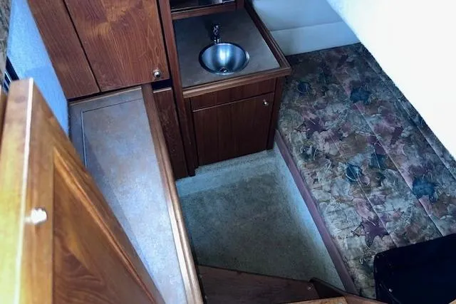 Slide: The Image of Interior of 1996 Bayliner 3388 Command Bridge Motoryacht with sink and patterned flooring. - 9