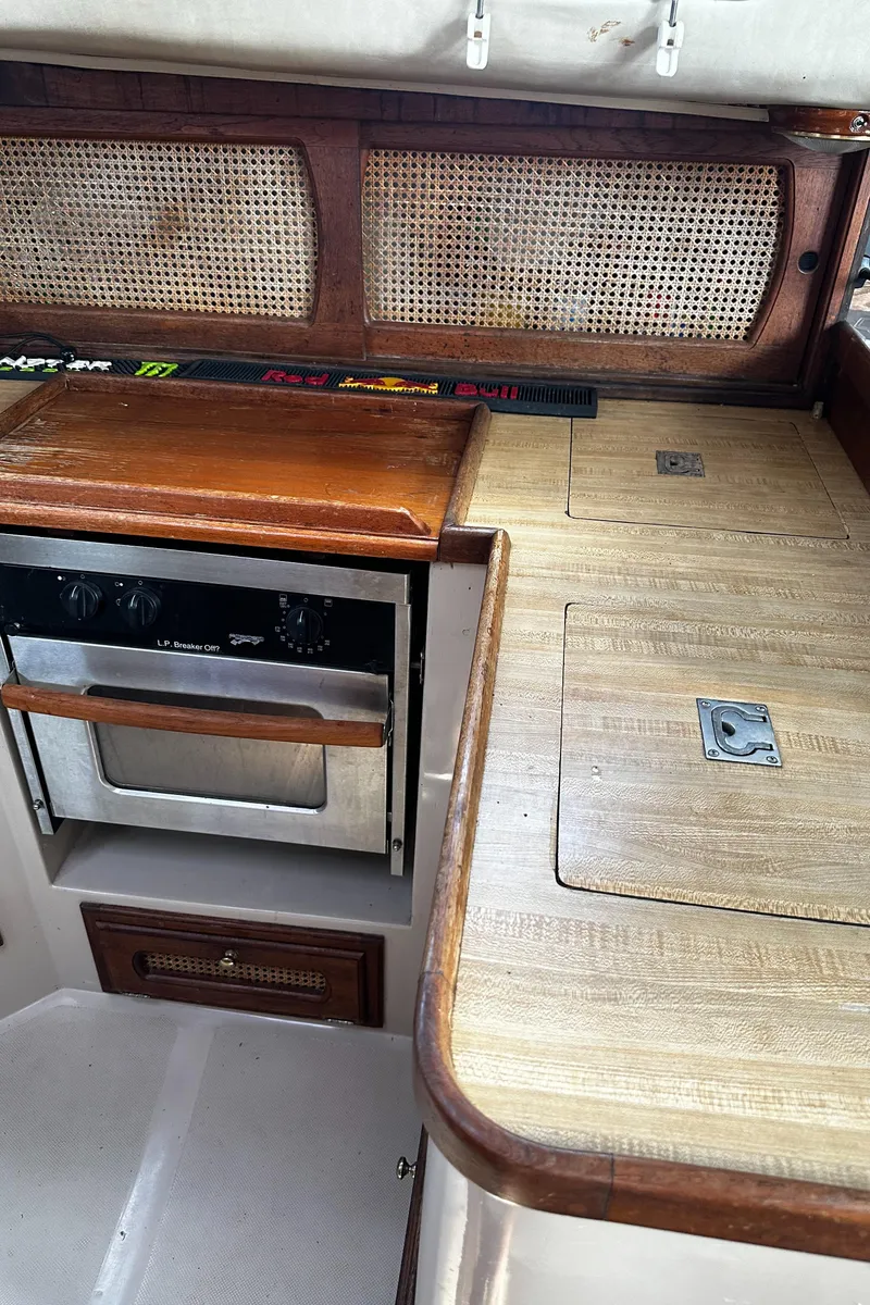 Slide: The Image of 1980 Lancer 36 yacht interior with wooden cabinetry and built-in oven. - 27