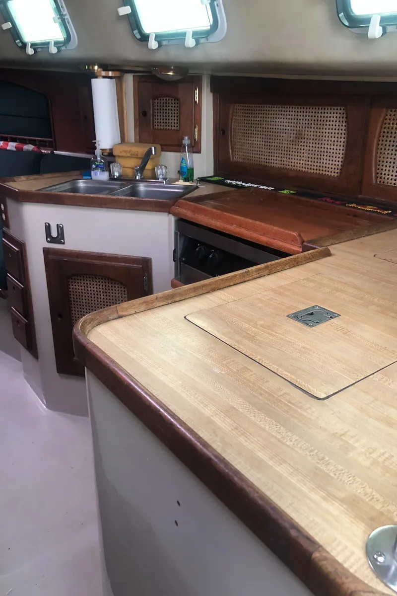 Slide: The Image of 1980 Lancer 36 yacht interior kitchen with wood finish and modern amenities. - 29