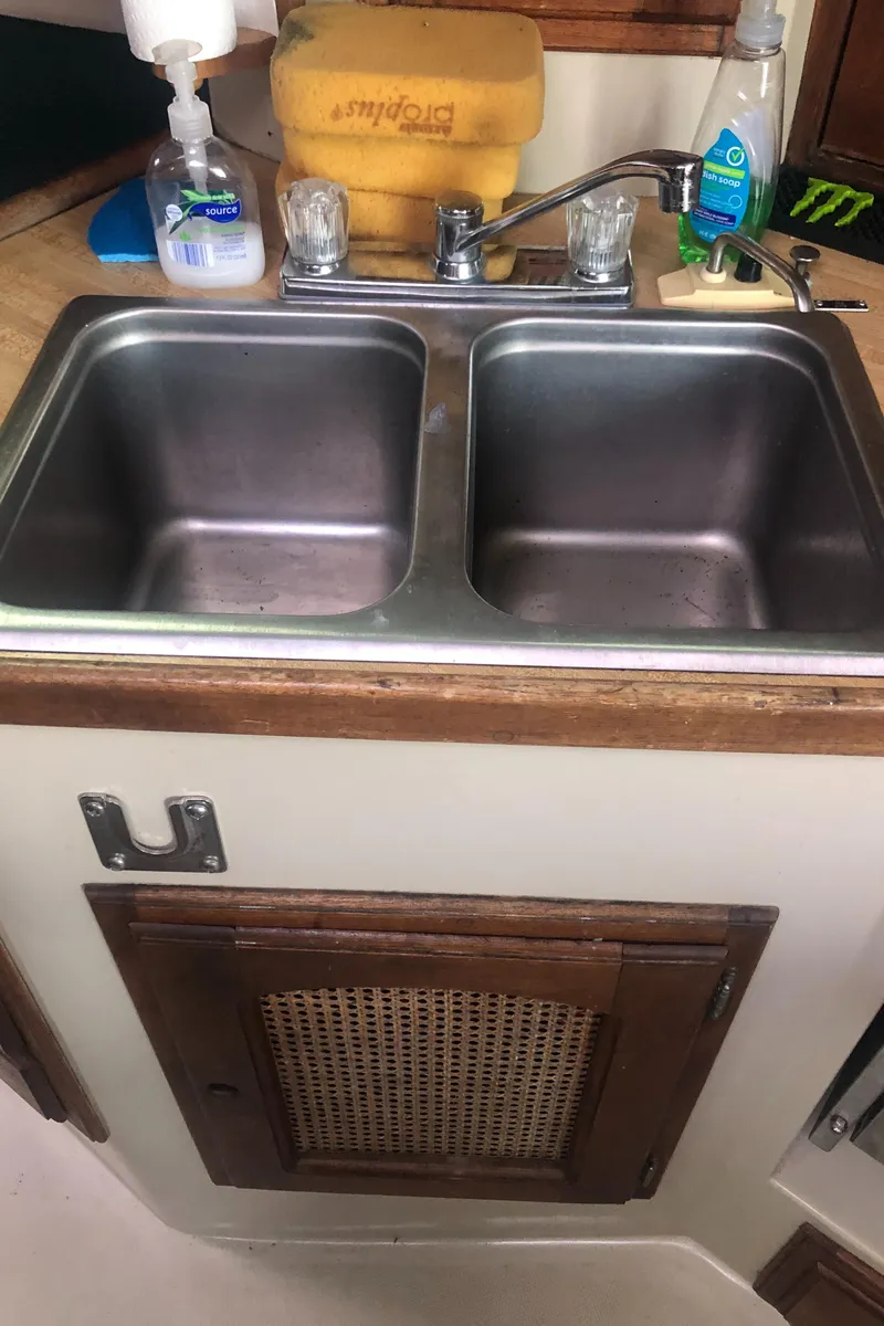 Slide: The Image of 1980 Lancer 36 kitchen sink with dual basins and wooden cabinetry. - 30