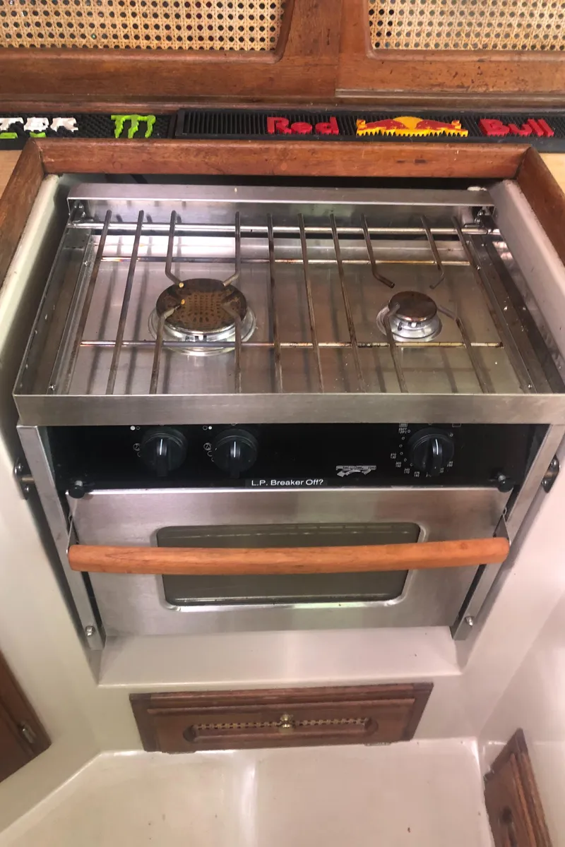 Slide: The Image of 1980 Lancer 36 boat kitchen with a two-burner stove and oven. - 32