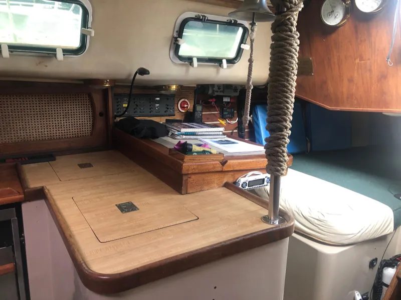 Slide: The Image of 1980 Lancer 36 yacht interior with navigation station, wooden cabinetry, and nautical instruments. - 37