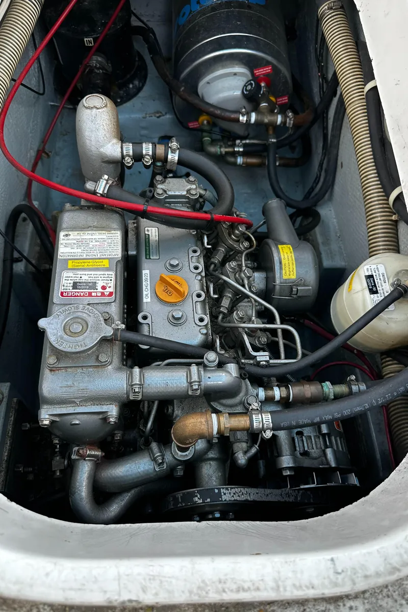 Slide: The Image of Engine compartment of a 1980 Lancer 36, featuring various mechanical components and hoses. - 48