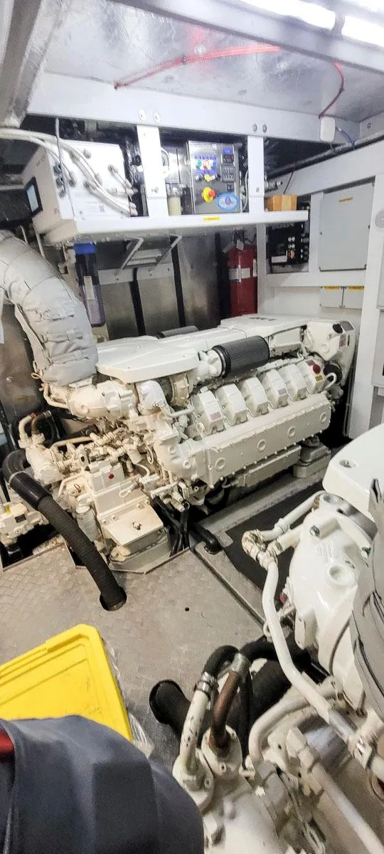 Slide: The Image of Engine room of 2017 Sunseeker 75 Yacht, showcasing powerful marine engine components. - 30