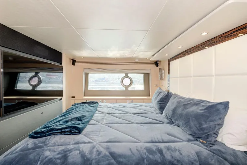 Slide: The Image of Luxurious bedroom interior of 2017 Sunseeker 75 Yacht with plush bedding and porthole window. - 45