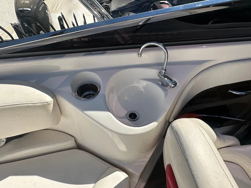 Slide: The Image of 2006 Regal 2450 Cuddy boat interior with sink and seating. - 14