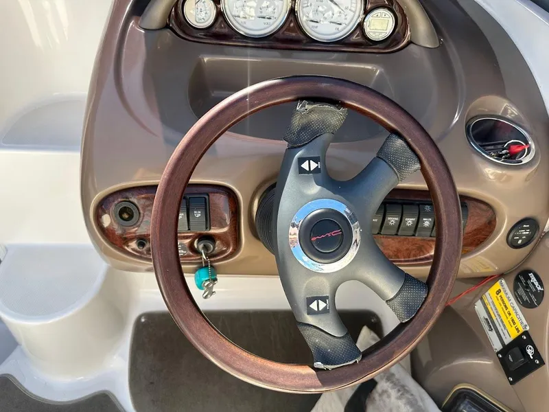 Slide: The Image of Steering wheel and dashboard of a 2006 Regal 2450 Cuddy boat. - 17
