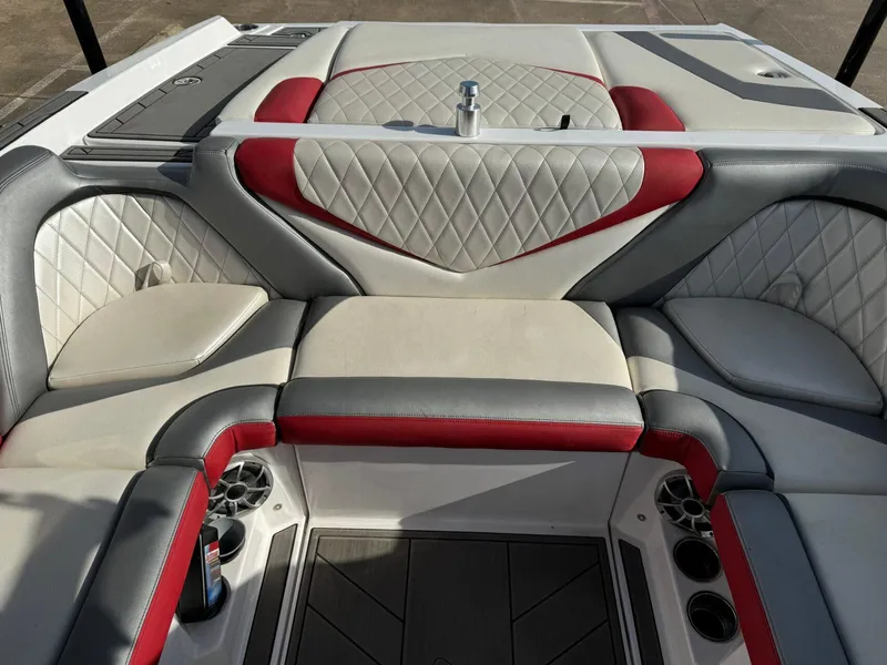 Slide: The Image of 2016 Tigé RZ2 boat interior with red and gray cushioned seating. - 11