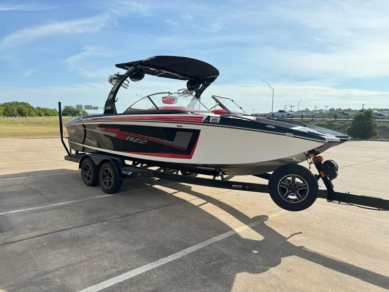 Slide: The Image of 2016 Tigé RZ2 boat on trailer in parking lot, sunny day. - 3
