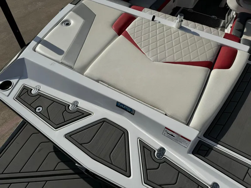 Slide: The Image of 2016 Tigé RZ2 boat interior with white and red cushioned seating. - 5