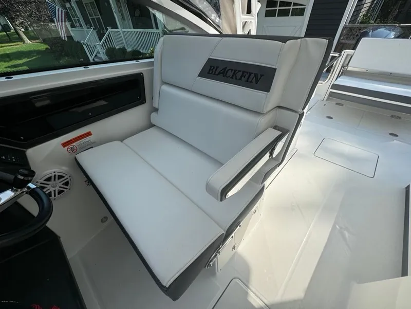 Slide: The Image of 2020 Blackfin 272 DC boat interior with white seating and armrest. - 11
