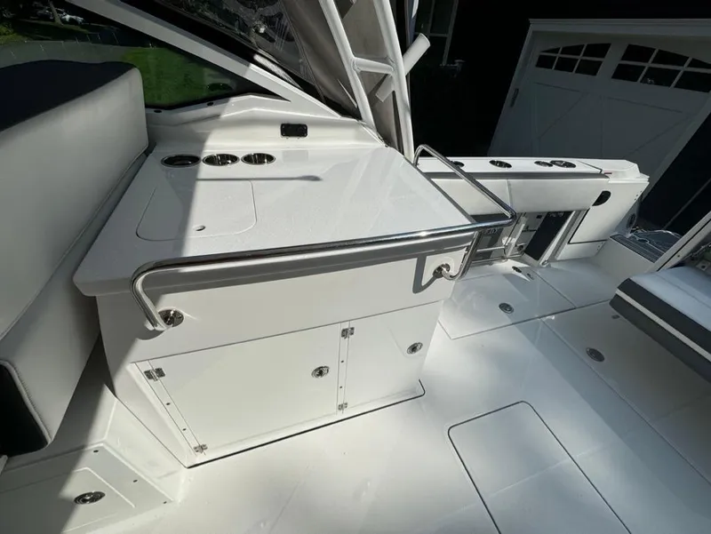 Slide: The Image of 2020 Blackfin 272 DC boat interior with sleek white cabinetry and stainless steel accents. - 14