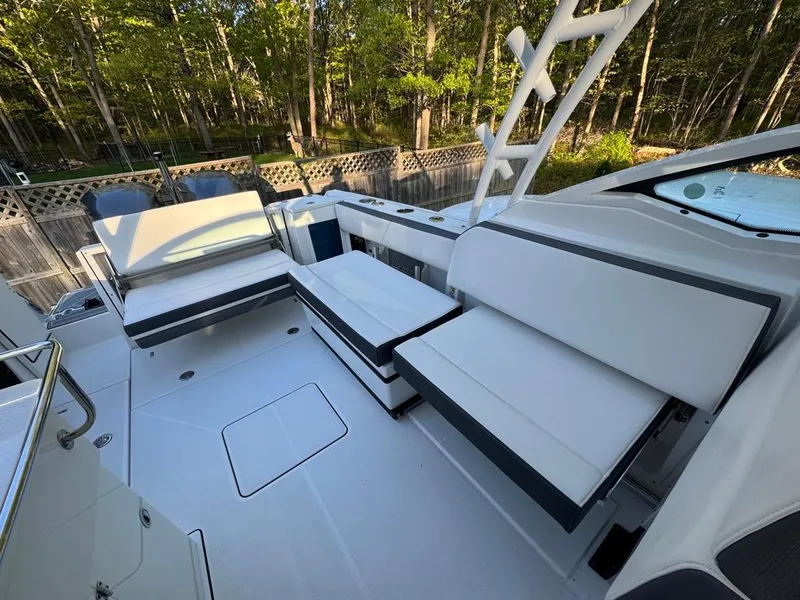 Slide: The Image of 2020 Blackfin 272 DC boat interior with white seating and wooded background. - 17
