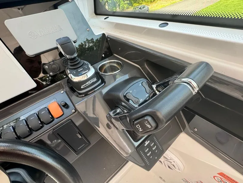 Slide: The Image of 2020 Blackfin 272 DC boat cockpit with controls and steering wheel. - 20