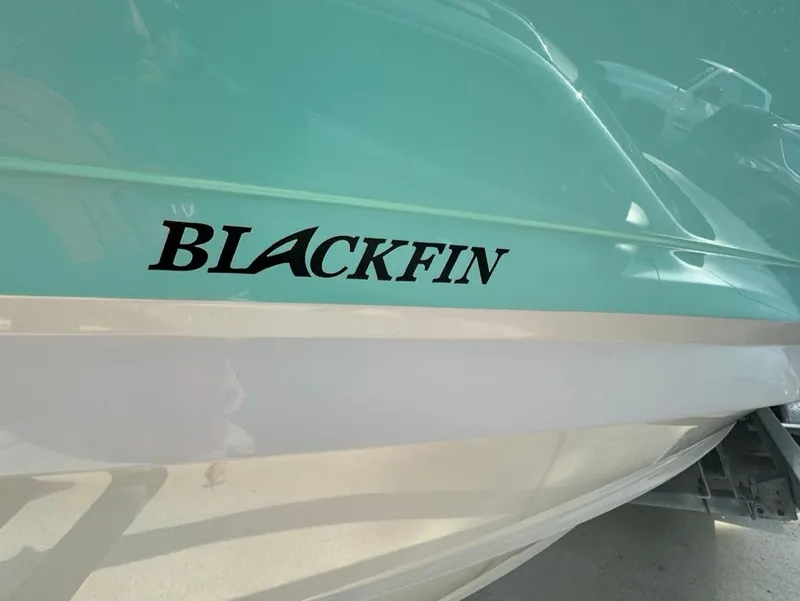 Slide: The Image of 2020 Blackfin 272 DC boat with teal and white hull. - 27