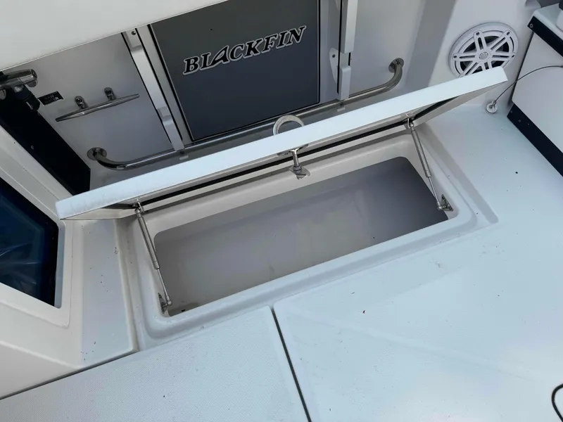 Slide: The Image of 2020 Blackfin 272 DC boat storage compartment with open lid. - 29