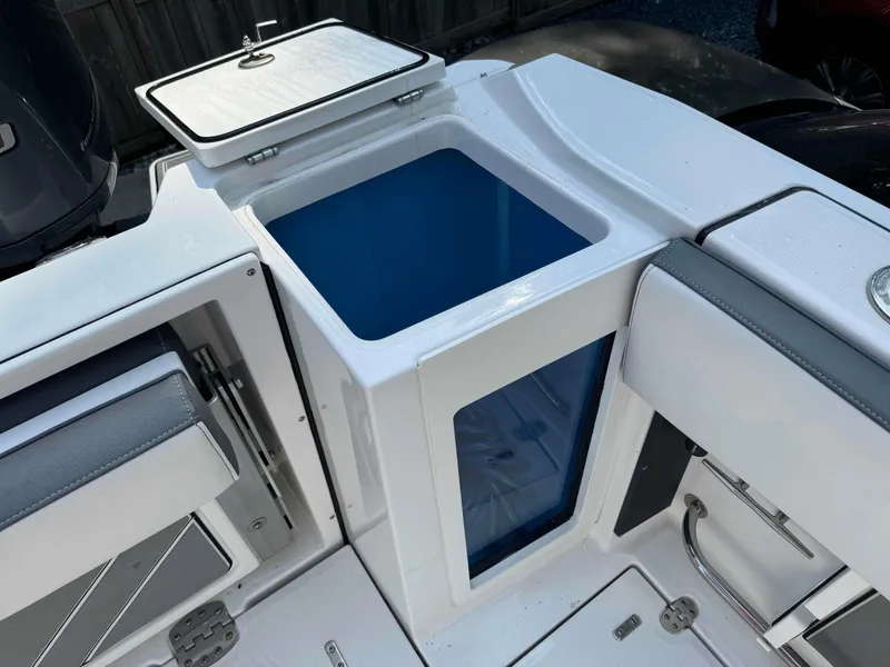 Slide: The Image of 2020 Blackfin 272 DC boat interior with storage compartment and seating. - 31