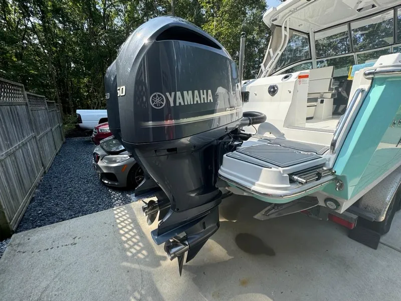 Slide: The Image of 2020 Blackfin 272 DC boat with Yamaha outboard motor, parked on concrete driveway. - 34