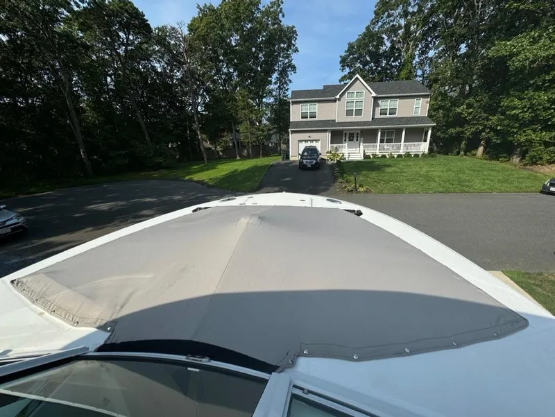 Slide: The Image of 2020 Blackfin 272 DC boat parked in a residential driveway. - 35