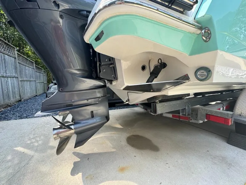 Slide: The Image of 2020 Blackfin 272 DC boat on trailer, showcasing outboard motor and hull design. - 37