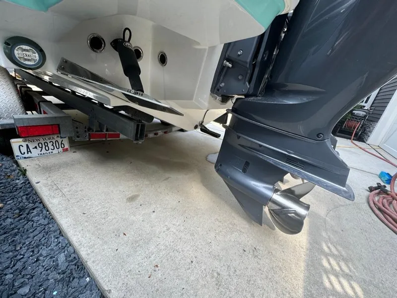 Slide: The Image of 2020 Blackfin 272 DC boat on trailer, showing outboard motor and license plate. - 40