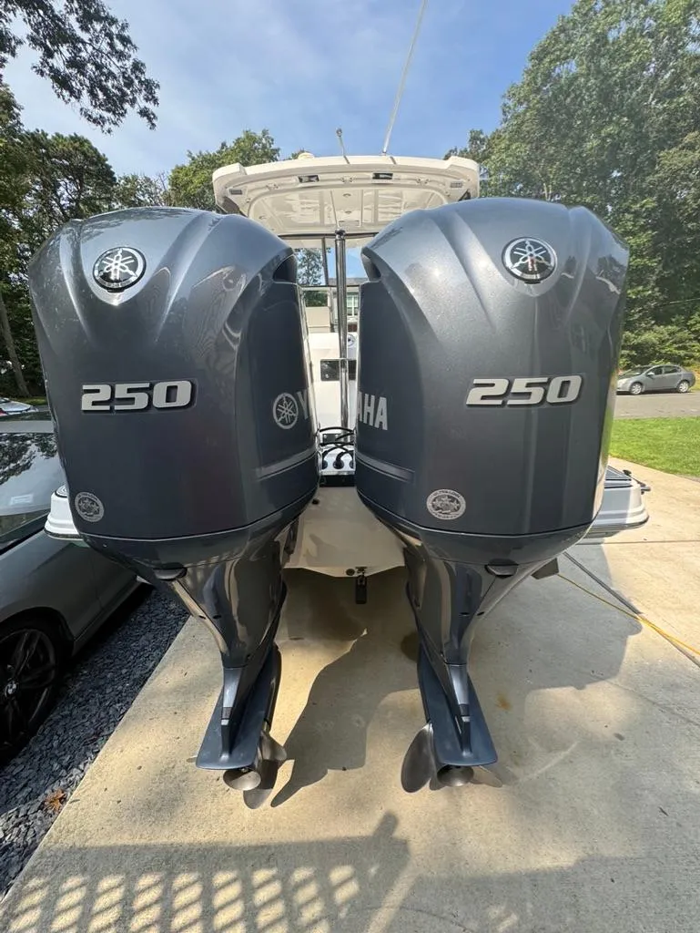 Slide: The Image of 2020 Blackfin 272 DC with twin Yamaha 250 outboard engines, parked outdoors. - 43