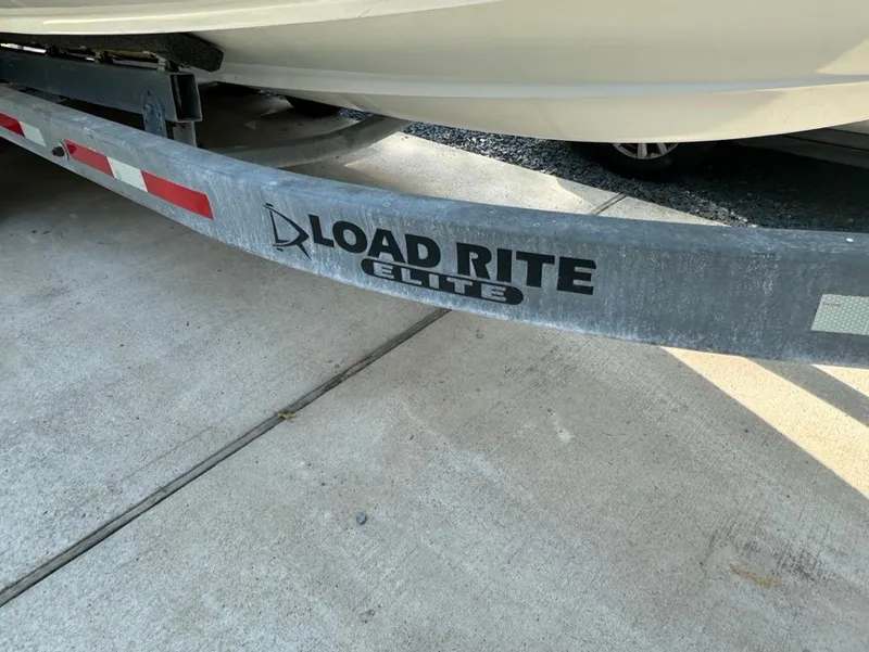 Slide: The Image of Load Rite Elite trailer with 2020 Blackfin 272 DC boat on concrete surface. - 45