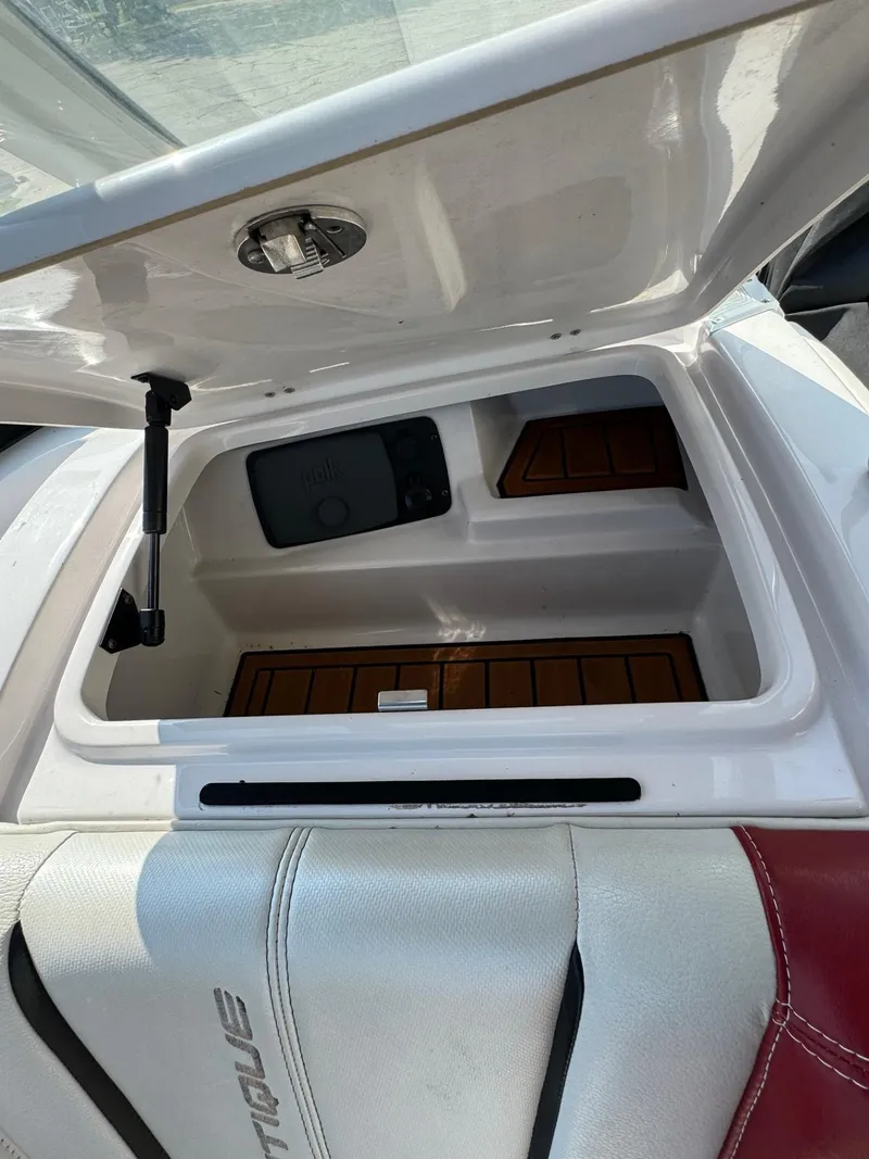 Slide: The Image of Open storage compartment in 2014 Nautique G23 boat interior. - 18