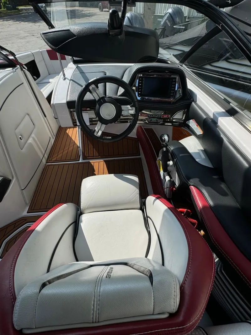 Slide: The Image of Interior of 2014 Nautique G23 boat with steering wheel and dashboard. - 19
