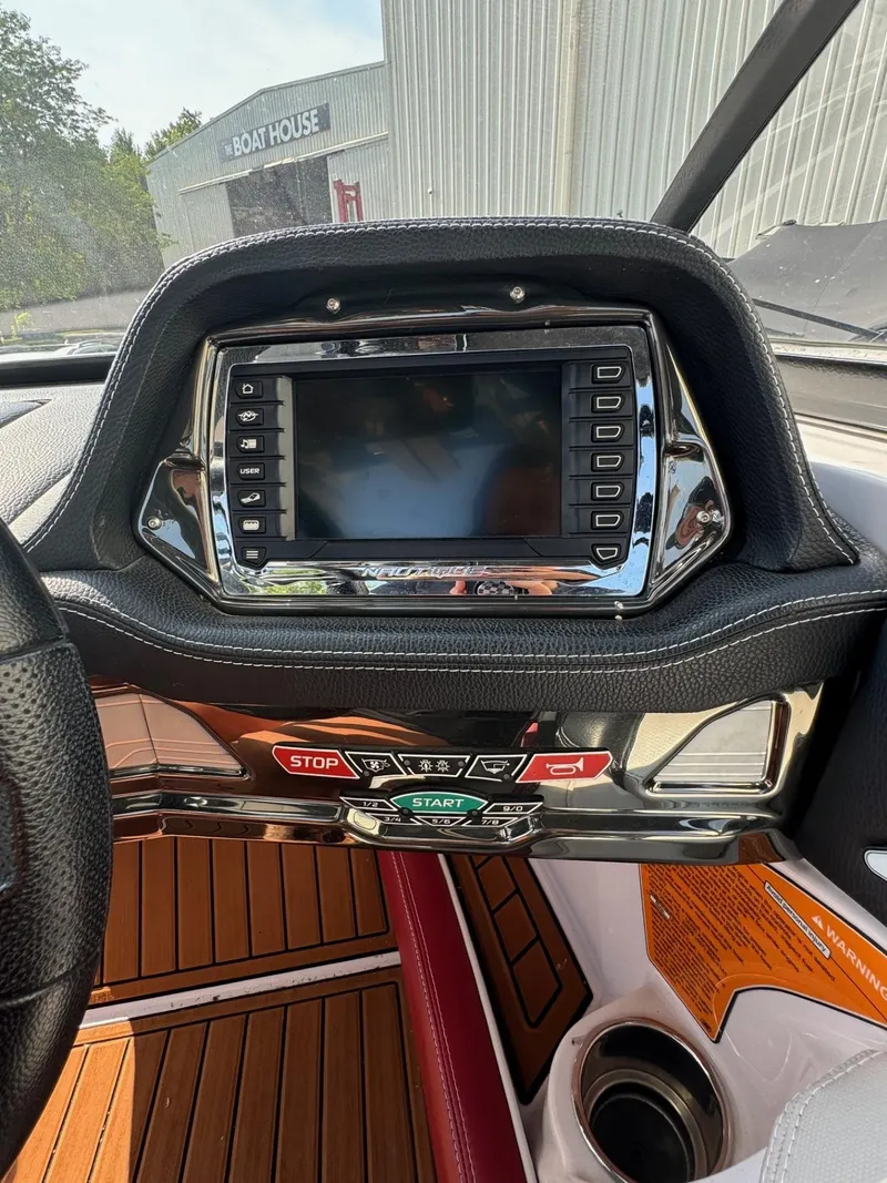 Slide: The Image of 2014 Nautique G23 dashboard with touchscreen and control buttons. - 20