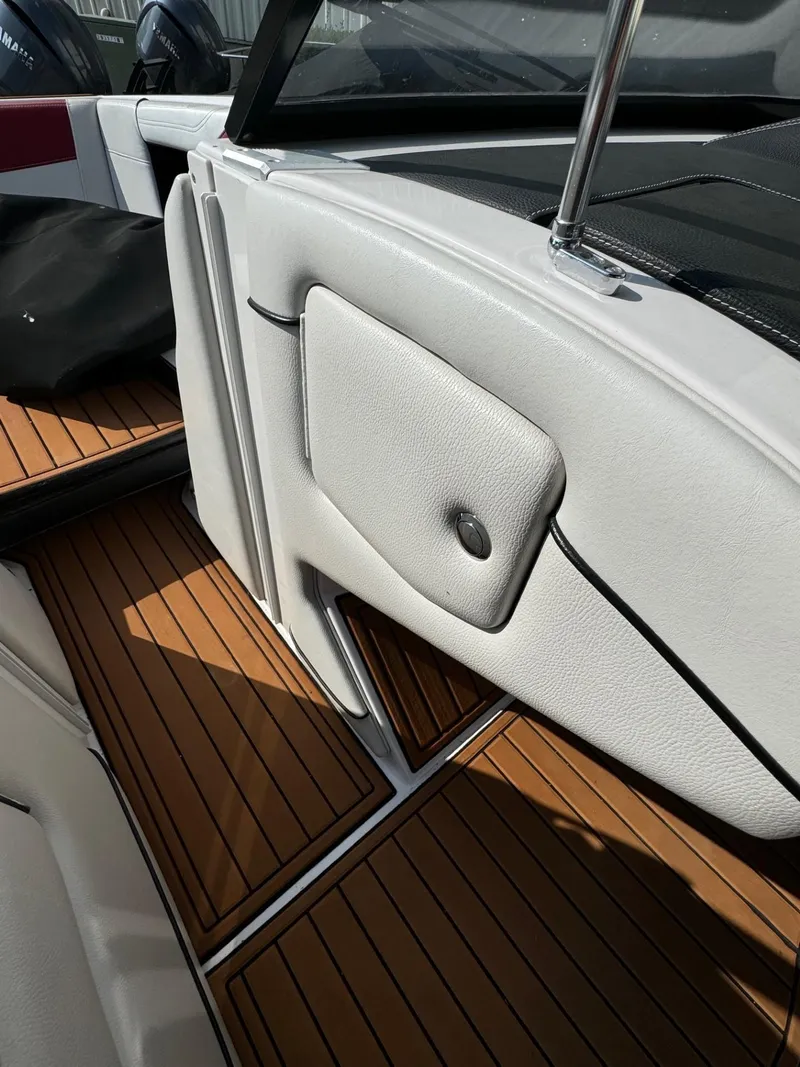 Slide: The Image of 2014 Nautique G23 interior with teak flooring and white upholstery. - 21
