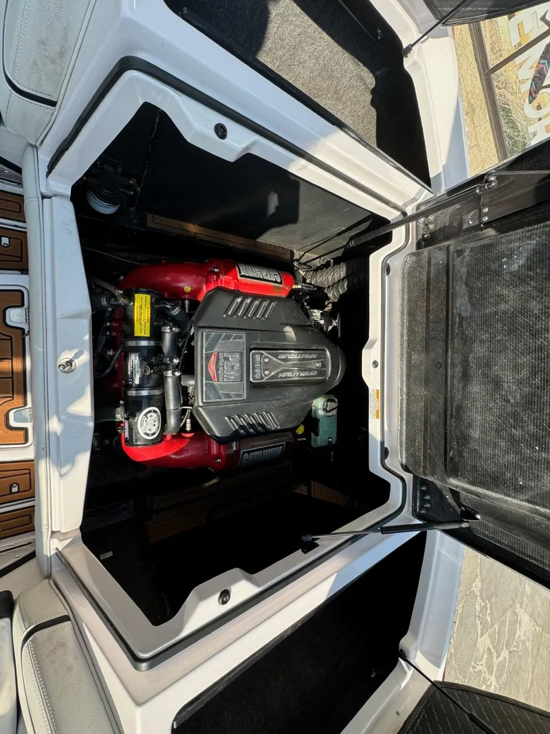 Slide: The Image of 2014 Nautique G23 engine compartment with visible components and detailing. - 23