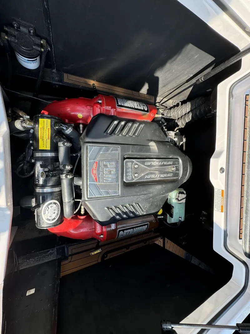 Slide: The Image of 2014 Nautique G23 engine compartment with powerful inboard motor. - 24