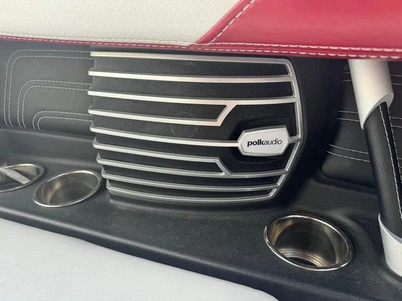 Slide: The Image of Polk Audio speaker in 2014 Nautique G23 boat interior with cup holders. - 25