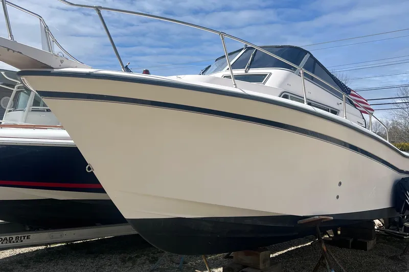 Slide: The Image of 1998 Grady-White Voyager 268 boat on display, featuring sleek design and sturdy build. - 1