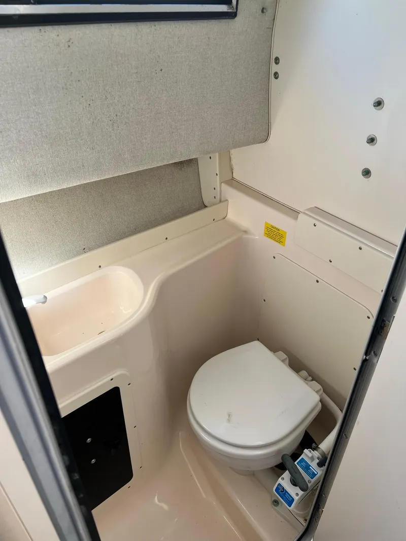 Slide: The Image of 1998 Grady-White Voyager 268 boat bathroom with toilet and sink. - 14