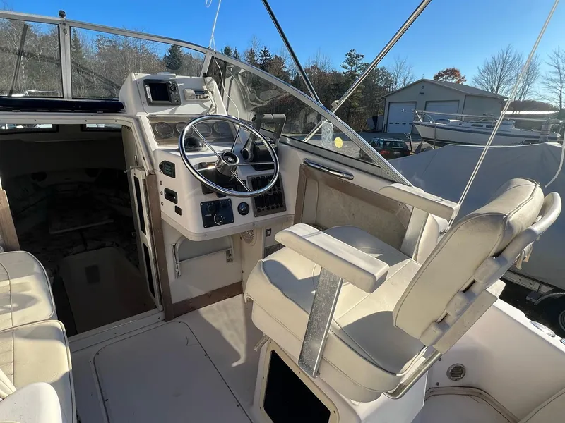 Slide: The Image of 1998 Grady-White Voyager 268 boat cockpit with steering wheel and captain's chair. - 2