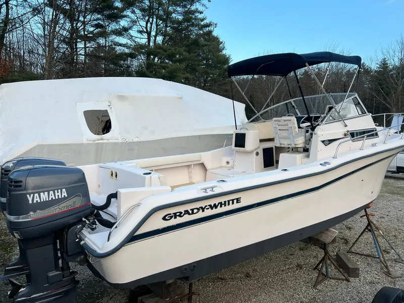 Slide: The Image of 1998 Grady-White Voyager 268 boat with Yamaha outboard motor, parked outdoors. - 3