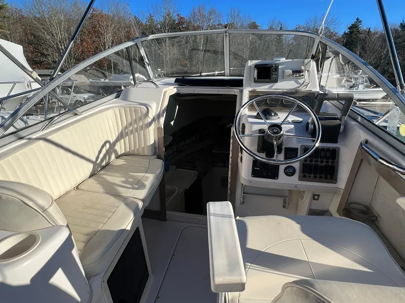Slide: The Image of 1998 Grady-White Voyager 268 boat interior with steering wheel and seating area. - 4