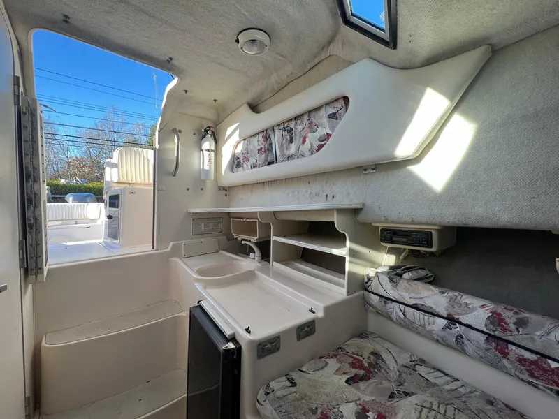 Slide: The Image of Interior of 1998 Grady-White Voyager 268 boat with compact kitchen and seating area. - 5
