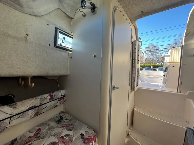 Slide: The Image of Interior cabin of 1998 Grady-White Voyager 268 boat with cozy sleeping area. - 6