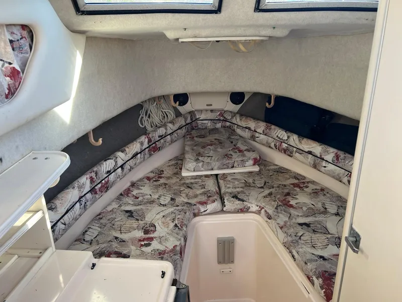 Slide: The Image of 1998 Grady-White Voyager 268 cabin interior with floral upholstery and storage compartments. - 7