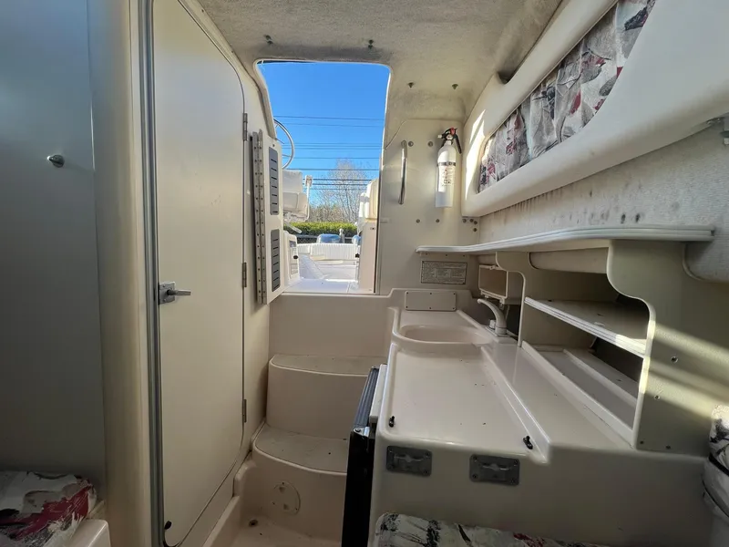 Slide: The Image of Interior of 1998 Grady-White Voyager 268 boat, featuring storage and seating areas. - 8