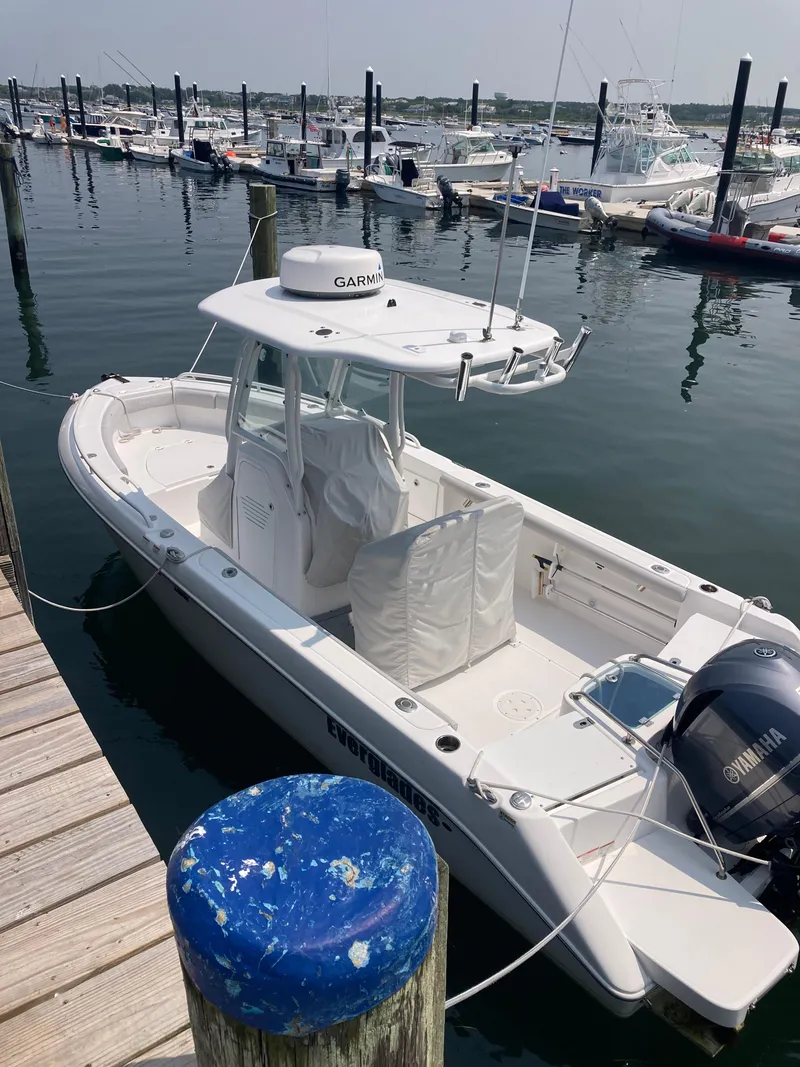 Slide: The Image of 2020 Everglades 235 Center Console boat docked in a marina. - 20