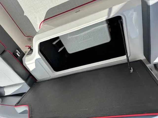 Slide: The Image of 2025 Regal LS4 boat storage compartment with cooler, featuring sleek interior design. - 10