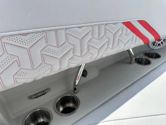 Slide: The Image of 2025 Regal LS4 boat interior with geometric upholstery and cup holders. - 12