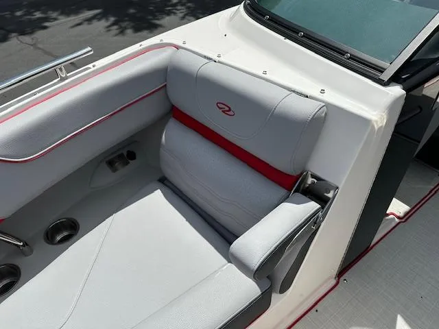 Slide: The Image of 2025 Regal LS4 boat interior with gray and red seating, cup holders, and sleek design. - 15