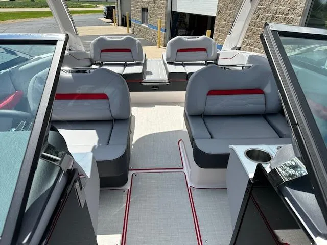 Slide: The Image of 2025 Regal LS4 boat interior with gray seating and red accents. - 17
