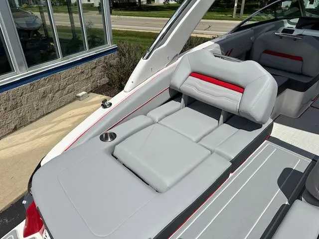 Slide: The Image of 2025 Regal LS4 boat interior with gray and red seating, cup holder, and modern design. - 19